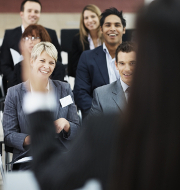 Happy group of business people sitting at a conference